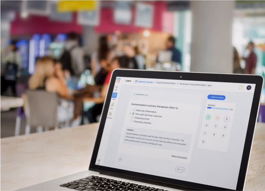 Laptop on a table displaying a Clover Learning quiz, set in a busy café environment with people blurred in the background.